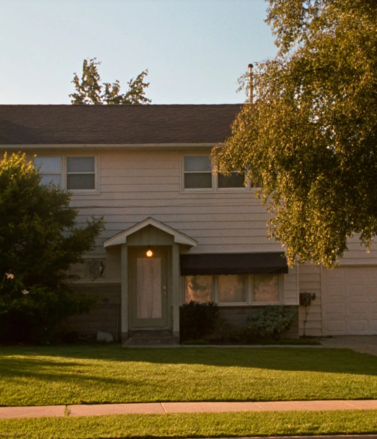 A managed single-family rental home in Sioux Falls photographed from the street at golden hour